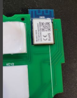 Close-up of a green PCB with a mounted module featuring CE and RoHS markings.