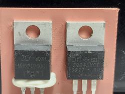 Two TO-220 components: MBR20200CT and 20B45VCT on PCB Two TO-220 semiconductor components on a PCB with visible markings and metal tabs.
