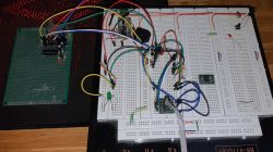 Zbliżenie na prototypową płytkę PCB i płytkę stykową z kolorowymi przewodami.