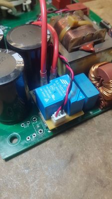 Close-up of internal electronic components with capacitors and wires.