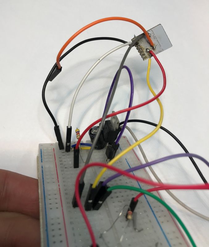 Breadboard with connected colorful wires.