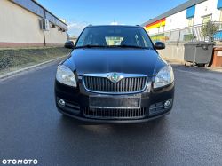 Black Škoda car parked on a lot, photographed from the front.