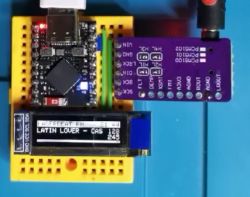 ESP32-S3 Supermini module connected to a breadboard with an OLED display showing the text LATIN LOVER - CAS.