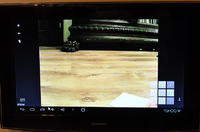 How can I stream footage from a camera at work to my TV at home via the internet?