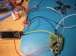 Circuit board with connected wires on a specialized workstation.