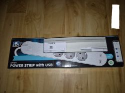 LSC Smart Connect white power strip with USB ports in original packaging on a wooden floor.