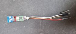CB2S module with step down converter and wires on a black background.