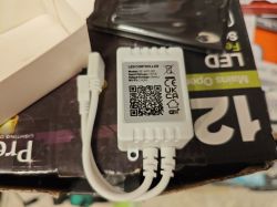 Wi-Fi LED controller with three connectors and QR code lying on a box