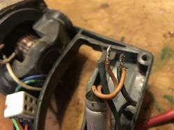 Repairing an Old Electric Drill Disassembled electric drill with visible wires and motor fragment.