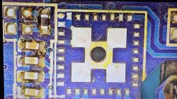 Close-up of PCB with Removed T34 Chip Close-up of a PCB with removed T34 chip, showing solder pads and traces.