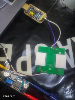 Electronic components connected by wires, including a PCB, USB programmer, and power module.