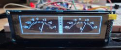 OLED display showing analog VU meters with L and R needle indicators and scale