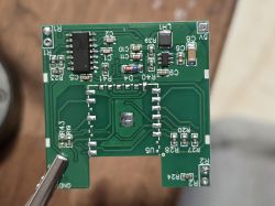 Close-up of a green PCB with surface-mounted electronic components