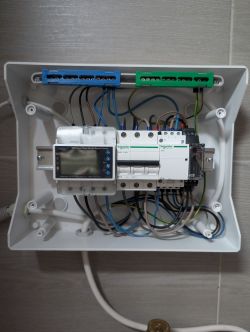 Control box with Schneider Electric modules and wiring.