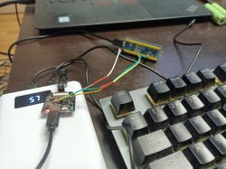 Small circuit board with wires next to a keyboard; display reads “57”.