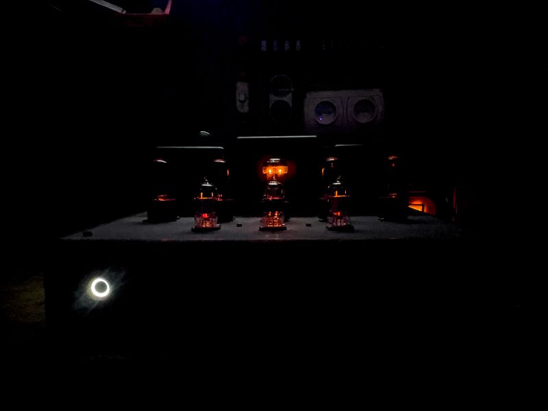 Tube Amplifier in Low Light Dark photograph of a tube amplifier with glowing tubes visible.
