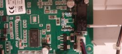 Close-up of a boiler motherboard from 2024 with visible electronic components.