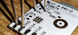 Close-up of a circuit board with probes attached.