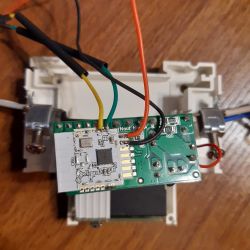 Electronic module with connected wires on a wooden surface background.