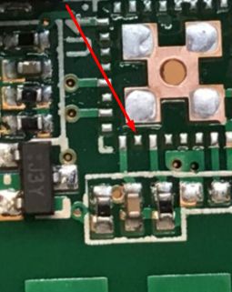 Unrouted UART Pin on PCB with LGA Footprint Close-up of a PCB with an LGA pad unconnected, pointed by a red arrow