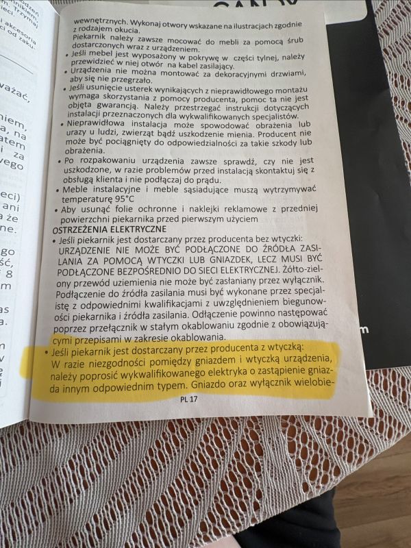 Strona instrukcji po polsku z ostrzeżeniami elektrycznymi, z podświetlonym na żółto fragmentem.