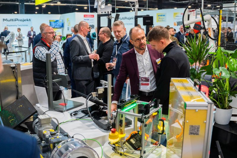 Men talking at an automation equipment booth during an industrial trade fair