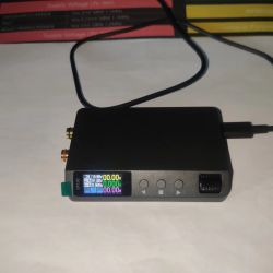 DP100 power supply with active LCD screen, control buttons and rotary knob visible