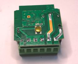 Electronic module with PCB and terminal connector Green PCB with visible traces, terminal block and soldered components.