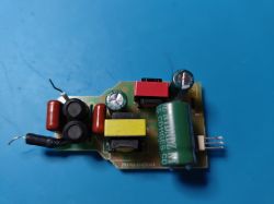 Circuit board with colorful electronic components on a blue background.