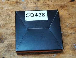 Box Labeled SB436 Black box labeled SB436 on a wooden background.