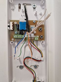 Interior of a Cyfral Smart 5P intercom with visible colored wires: blue, green, orange, gray, brown, and white.