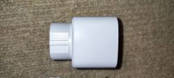 White Plastic Adapter White plastic adapter on a carpet background.