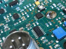 Close-up of a circuit board with electronic components and soldered elements.