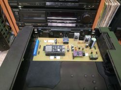 Mounted PCB inside audio tuner case with visible electronics and connectors