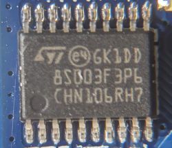 Close-up of STMicroelectronics Microchip Close-up of a microchip with visible markings and numbers.