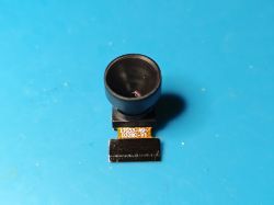 Wide-angle camera module on blue surface Wide-angle camera module with black lens on blue background