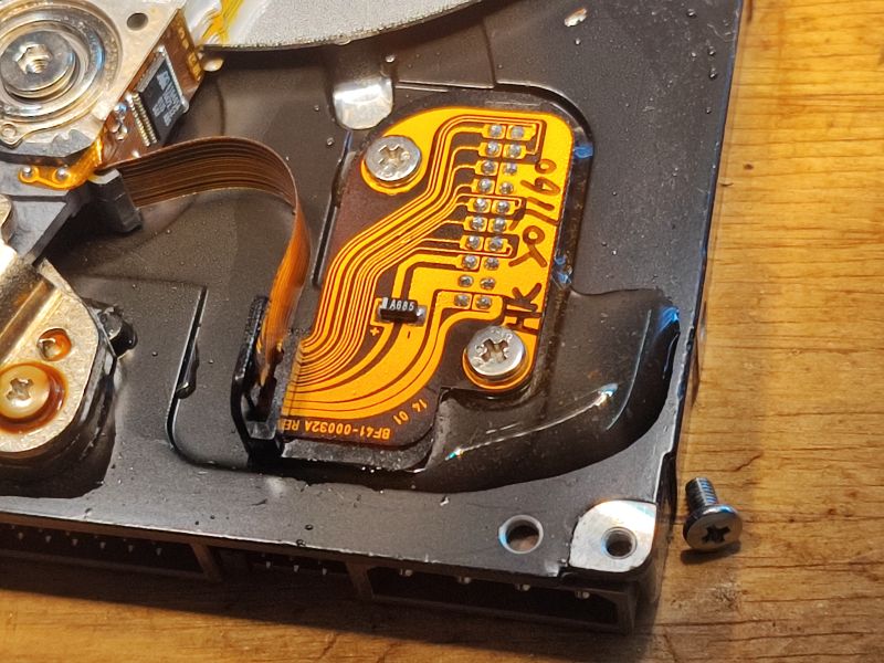 Interior of a Flooded Hard Drive Interior view of a hard drive with visible electronics and moisture traces.