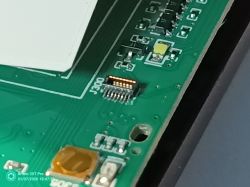 Close-up of J300 connector on green PCB with electronic components