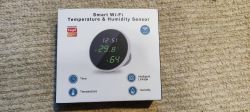 Packaging of a smart Wi-Fi temperature and humidity sensor with Tuya logo.