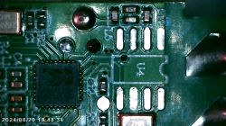 Close-up of a circuit board with visible electronic components and an integrated circuit.