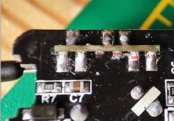 Close-up of a circuit board with soldered pins labeled TX, RX, GND, and 3.3.