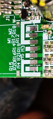 Close-up of a circuit board with component markings and solder points.