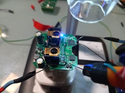 Tuya T34 circuit board with connected wires on a table.