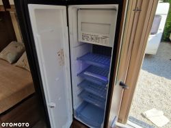 Open Dometic fridge inside a caravan.