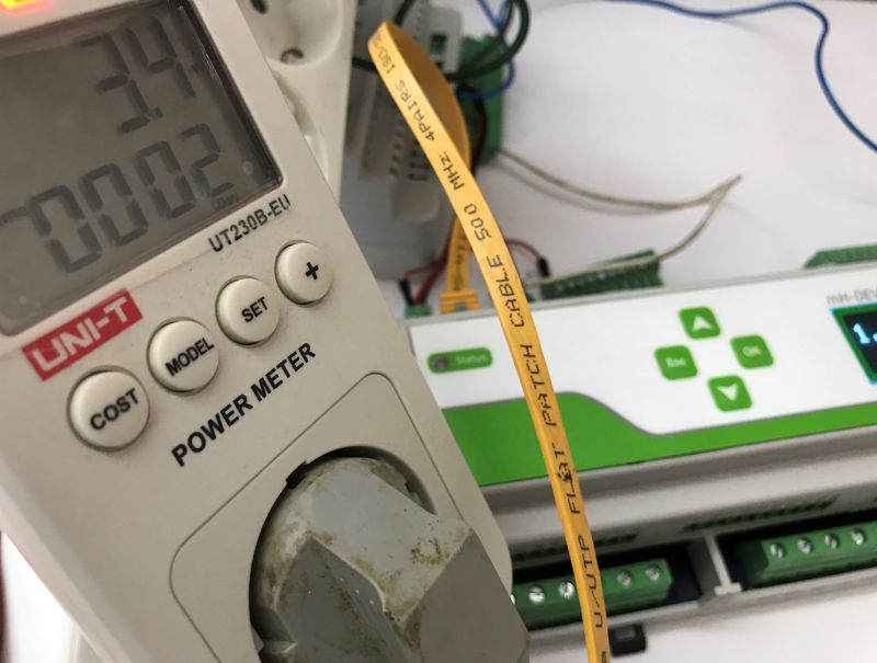UNI-T UT230B-EU power meter connected to electronic device with a yellow network cable in the foreground.