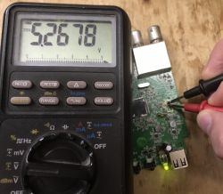 Voltage measurement of 5.27 V on DVB-T tuner PCB using a digital multimeter