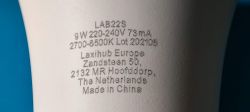 Close-up of a Laxihub LAB22S bulb with technical details and manufacturer's address.