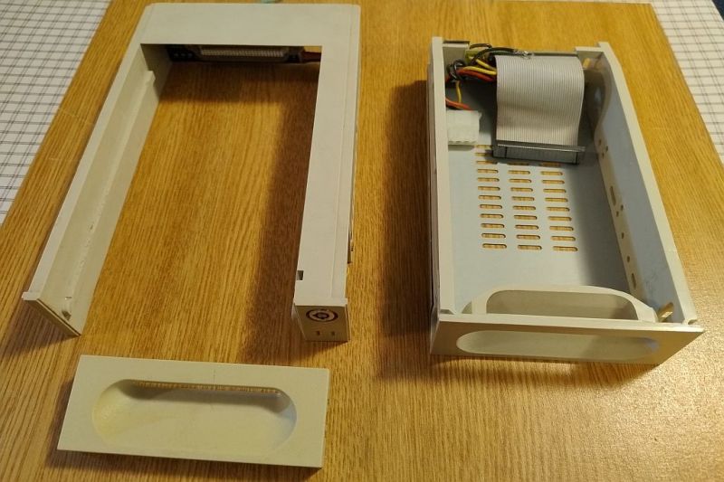 Hard drive bay with an open drawer, visible IDE ribbon cable.