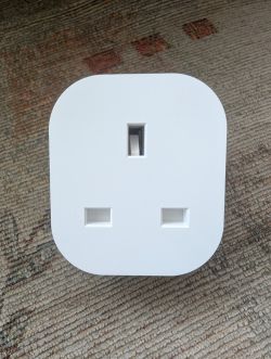 Minimalist White Plug White plug with a minimalist design on a carpet.