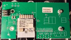 Printed Circuit Board with Mounted Module Printed circuit board with electronic components and a module with a QR code.